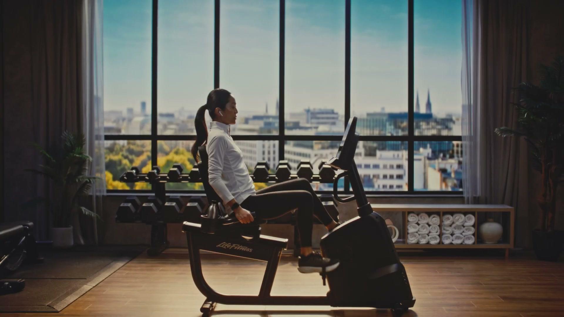 Life Fitness Atmos recumbent bike close-up at golden hour, brand visible
