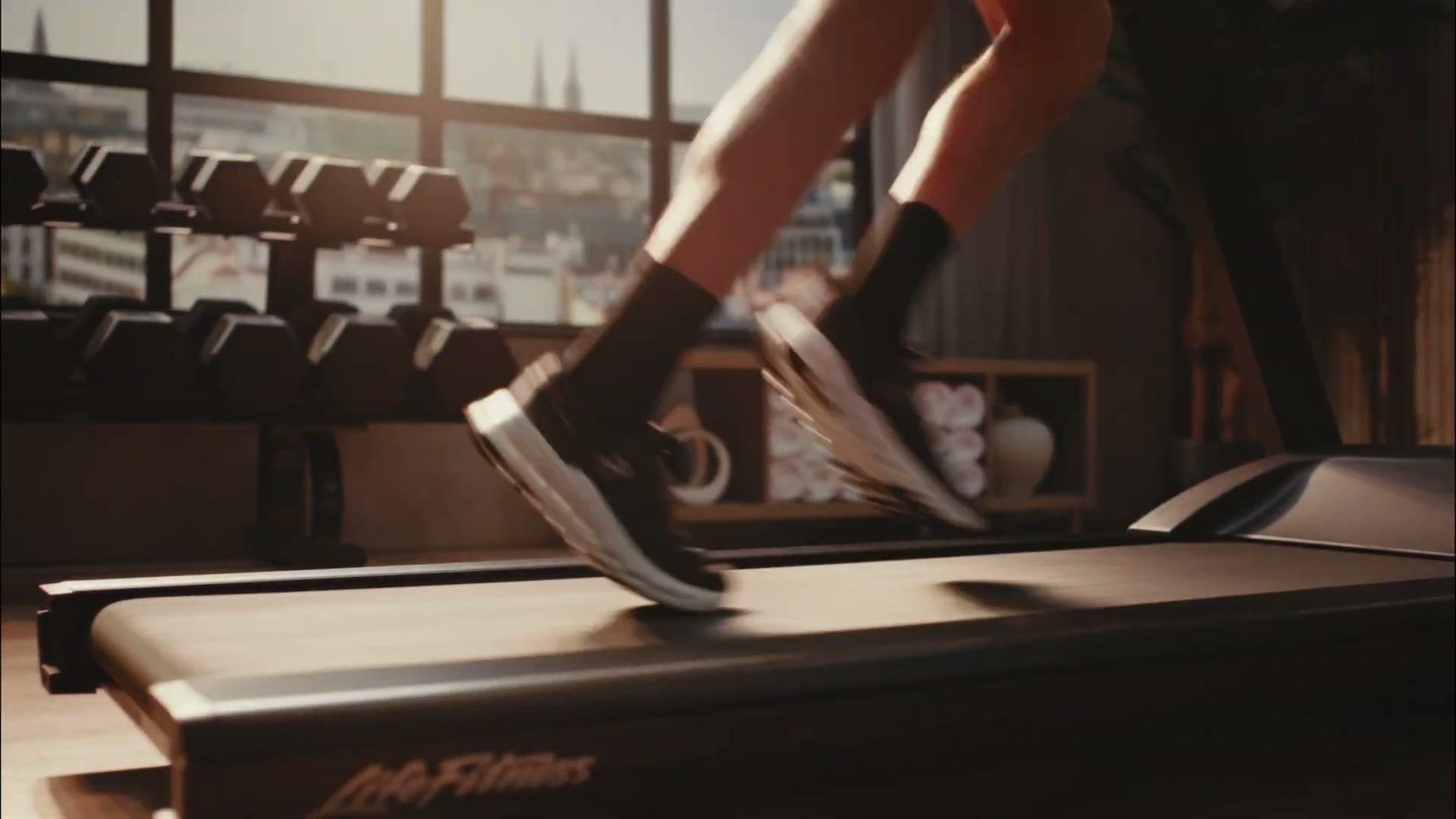 Life Fitness Atmos treadmill detail in the LED-lit hotel-gym set