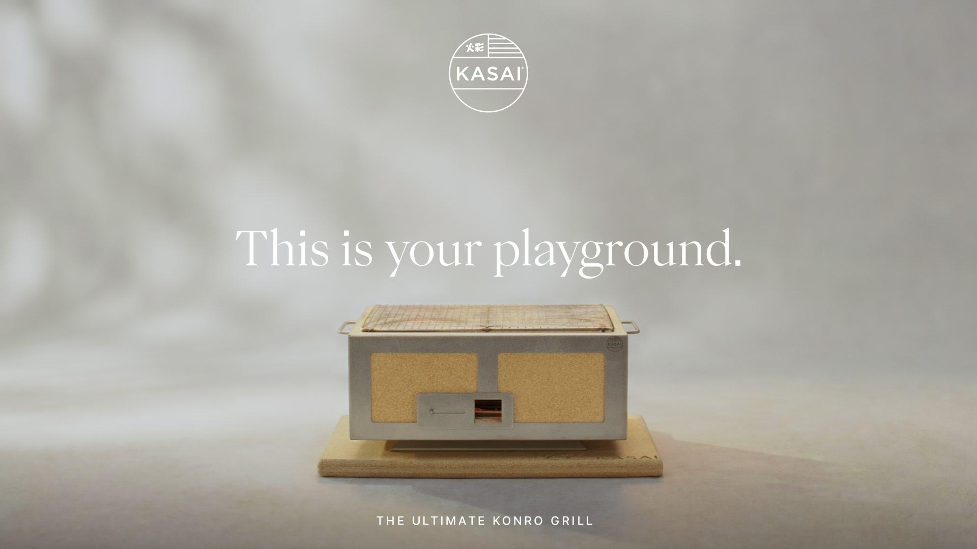 Kasai Konro grill on pale base, grey backdrop, Kasai logo top; headline This is your playground; strapline The Ultimate Konro Grill.