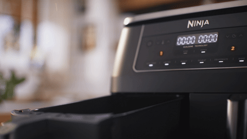 Golden chips falling into the Ninja DZ300 open drawer in mid-air, side angle 350fps.