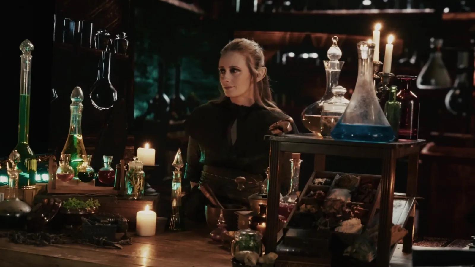 Elf alchemist reaches across a candlelit table of glowing potions.