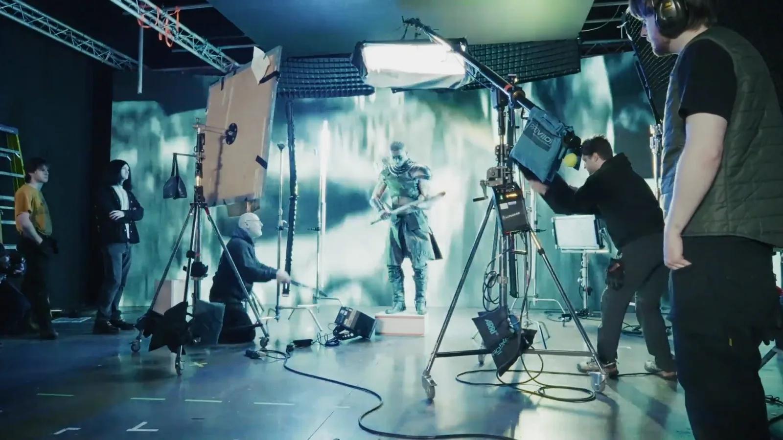 Armoured warrior on the LED volume before a snowy environment as the crew light the shot.