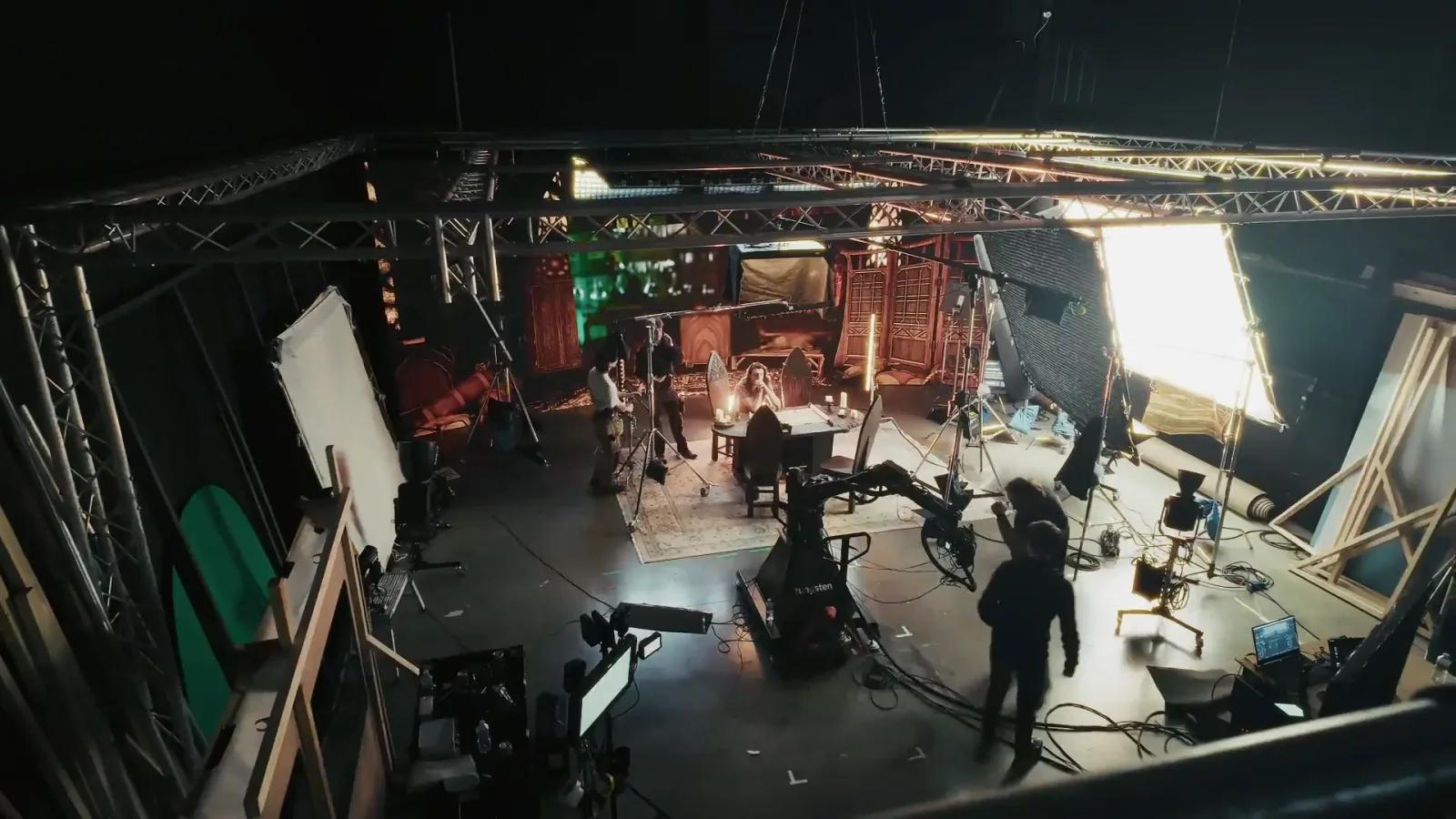 Overhead wide of the alchemist set on the studio stage, crew and lighting around it.